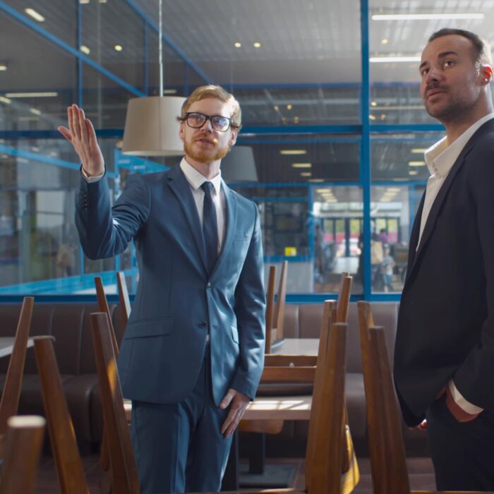 un conseiller en immobilier commercial et son client en visite de locaux professionnels